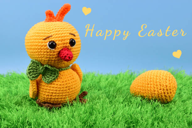 istock Chicken and egg on green grass with blue background 1338310533