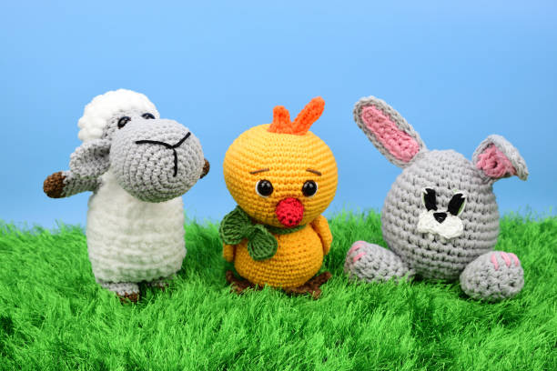 istock Easter symbols - lamb, chicken and rabbit standing on green grass against blue sky background 1338310573