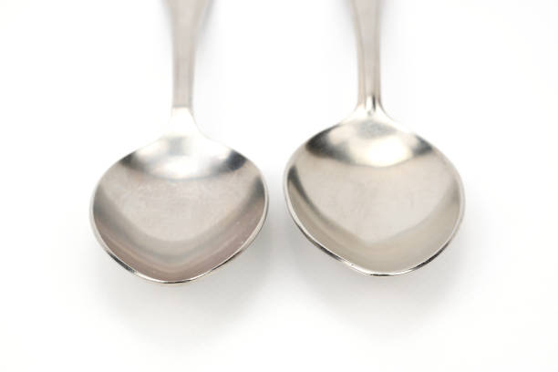 Metal spoon and fork on table