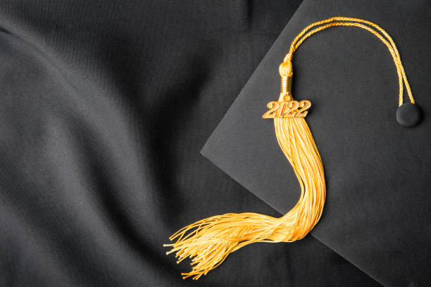 An overhead view of a class of 2022 tassel on a cap and gown.
