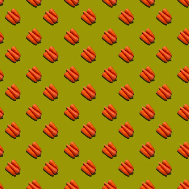 istock Seamless pattern from fresh juicy carrots on a uniform colored background. 1338312615
