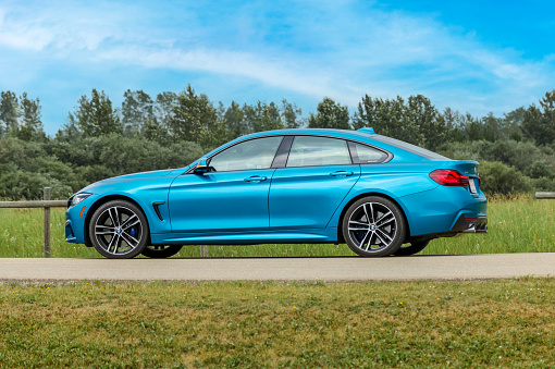 Rocky Mountain House, Alberta - July 22, 2021: A BMW 4 series sports car parked along a road in rural Alberta