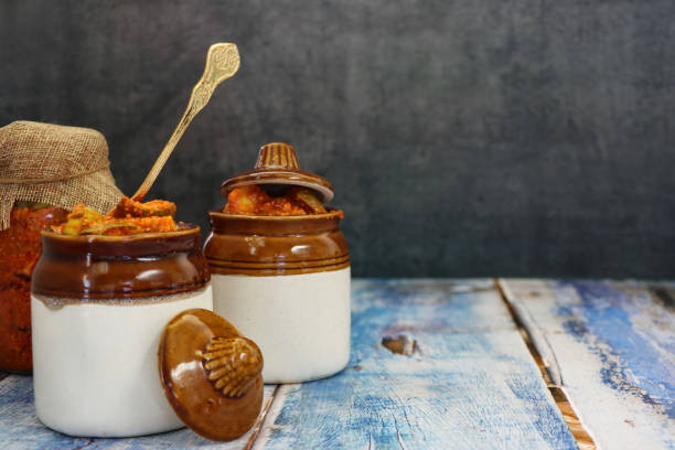 गर्मी में भूलकर भी न खाएं ये 5 चीजें, हो सकता है तगड़ा Reaction ! 4 image ceramic pickle lidded pots hessian covered glass jar of green mango chutney recipe