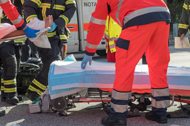 Ambulance Rescue workers place victim on rescue stretcher stretcher stock pictures, royalty-free photos & images