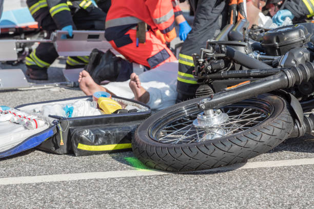 motorcycle_accident Rescue workers are trying to recover a seriously injured motorcyclist wreck stock pictures, royalty-free photos & images