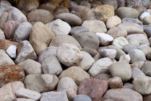 istock Different size rocks and boulders piled up in a heap, stone background 1338319576