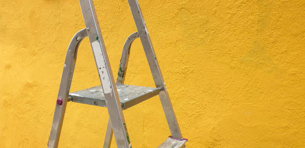 istock Ladder against freshly painted yellow wall 1338320609