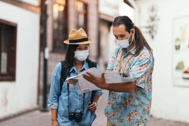 istock Japanese young woman asking for direction to tour guide 1338323884