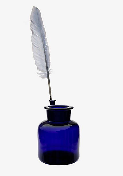 Feather and ink bottle stock photo