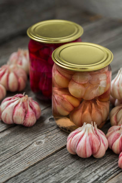 Pickled garlic in jars. Home canning, harvest.