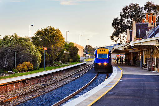 Intercity passenger train arraving at platform of railway station in Bathurst town of rural Australia.