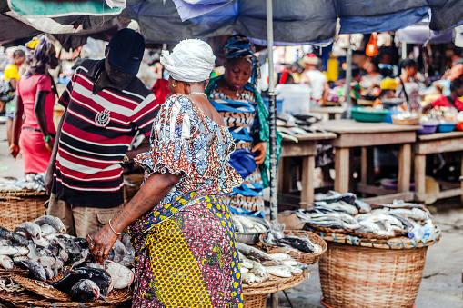 Lagos, Nigeria: Local women selling fresh fish at seafood market in Makoko area - called White Market.