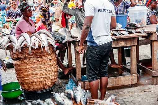 Lagos, Nigeria: Local women selling fresh fish at seafood market in Makoko area - called White Market.