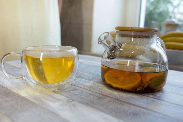 istock Tea with mint, tea and sliced lemon in a glass teapot on the table. 1338334270