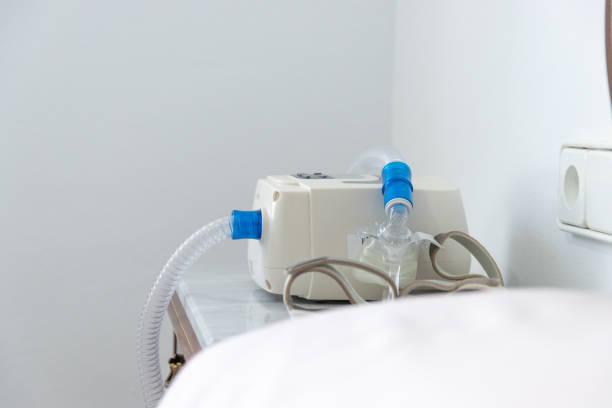 istock CPAP machine with air hose and head mask on bedside table 1338337118