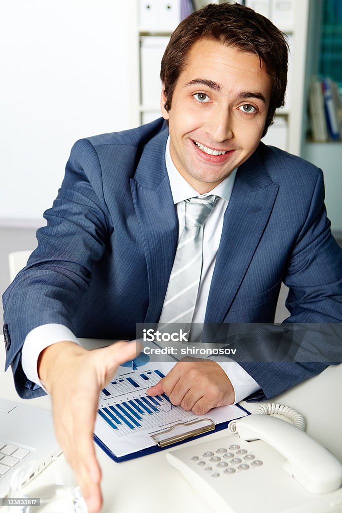Agree Portrait of a successful employer looking at camera while giving his hand for handshake Adult Stock Photo