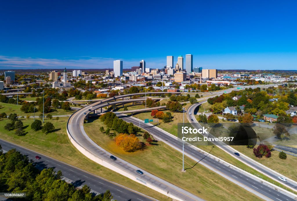 Aerial View of Downtown Tulsa Skyline with Freeways Aerial view of Downtown Tulsa skyline with grass, trees, and freeways in the foreground. Tulsa Stock Photo