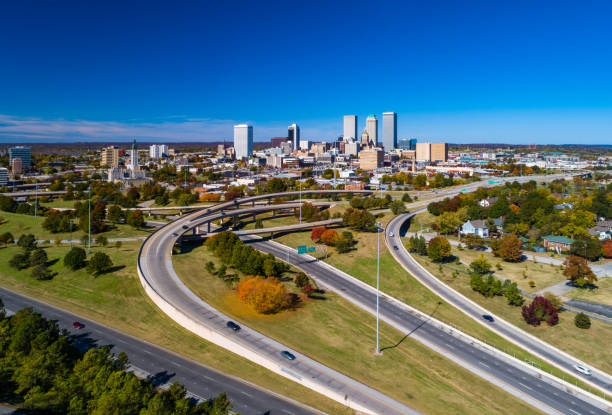 Aerial View of Downtown Tulsa Skyline with Freeways Aerial view of Downtown Tulsa skyline with grass, trees, and freeways in the foreground. oklahoma stock pictures, royalty-free photos & images