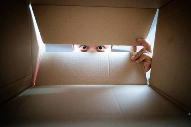 istock A man is surprised by what he finds in a box 1338350394