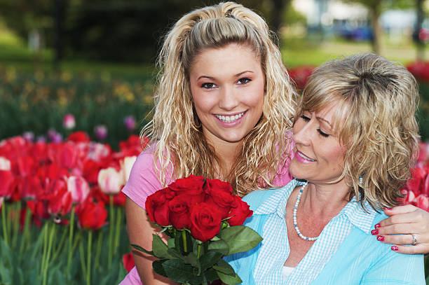 a daughter gives her mom flowers for a special occasion. Mother day conceptual idea.  
