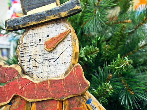istock wood snow man in front of christmas tree rustic 133836975