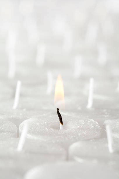 Several tea light candles arranged into a full frame image.  Reduced depth of field fading into the horizon