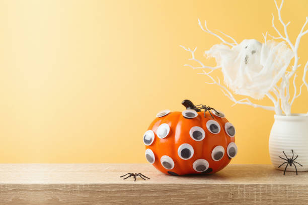 istock Halloween pumpkin creative decoration on wooden table. 1338373017