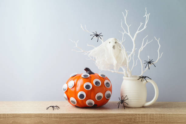 istock Halloween pumpkin and ghost creative decoration on wooden table. 1338373022