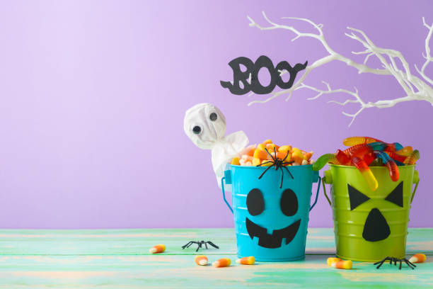 istock Halloween celebration concept with candy corn and candy in jack o lantern bucket for trick and treat 1338373031