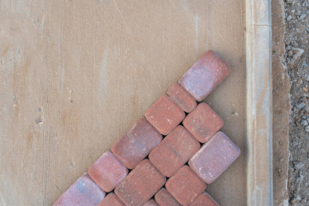 Laying paving stones on sand mixed with cement, top view