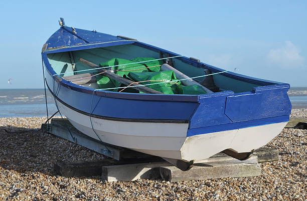 istock Fishing boat on shingle beach 133837588