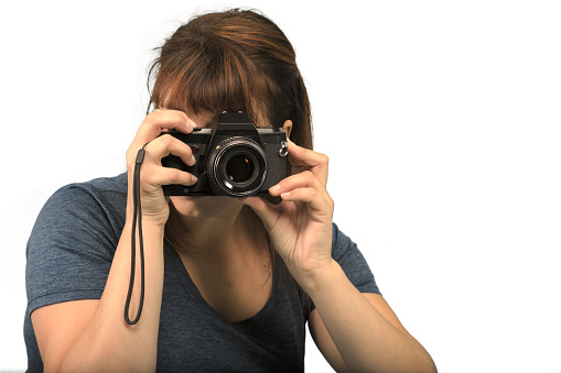 professional photographer woman taking picture holding camera white studio background