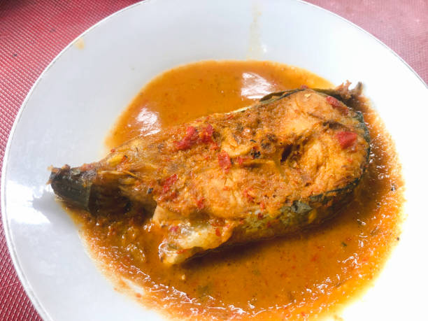 istock Fish spicy curry in side dish of Padang rice 1338380064