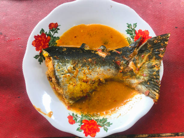 istock Fish spicy curry in side dish of Padang rice 1338380073