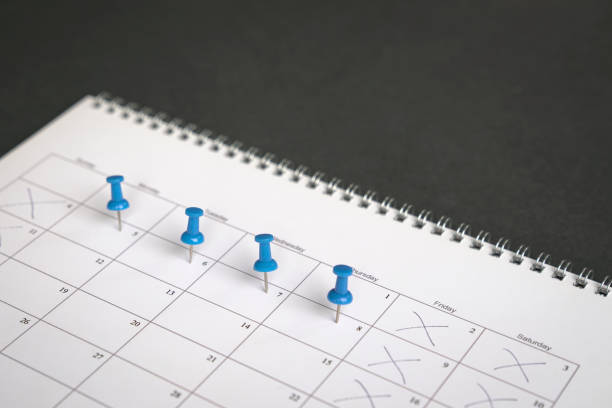 Four day work week concept. Blue pins on four days in a week on a calendar. Friday, Saturday and Sunday crossed out. Four day work week concept. day stock pictures, royalty-free photos & images