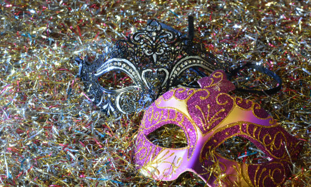 istock masks on a background of confetti and streamers 1338381820