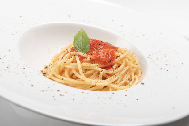 istock Spaghetti with tomato sauce, photo on the white background 1338389118