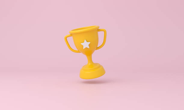 istock Trophy cup with a star on pink background. 1338389353