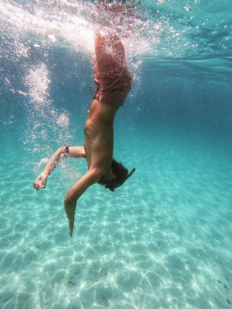 istock Man in boardshorts snorkeling 1338390199