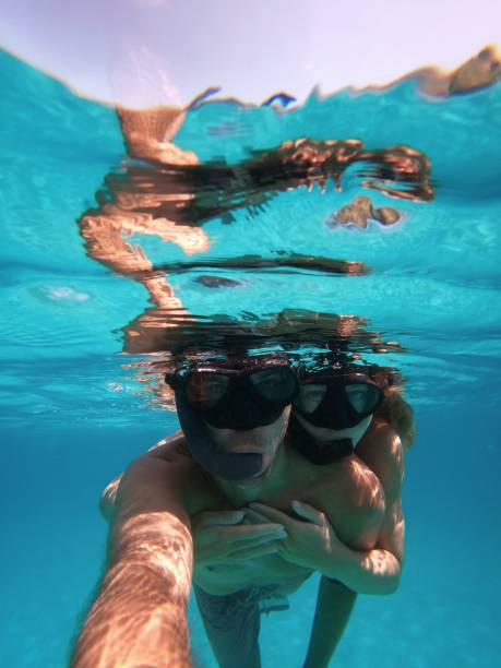 Couple snorkeling underwater selfie stock photo