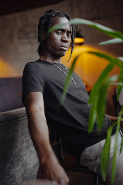 istock Portrait African man with dreadlocks sitting on chair 1338391014