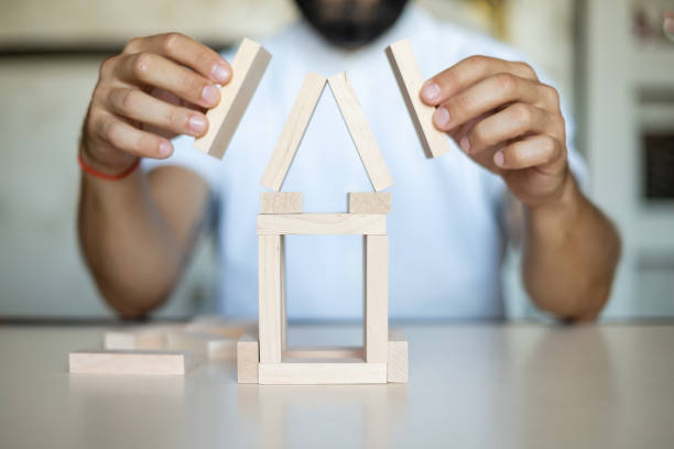 istock Business man placing wooden block on a tower concept risk control 1338391307