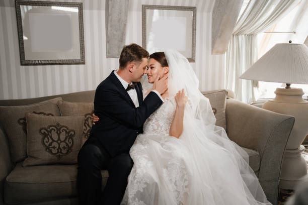 istock cheerful and happy bride and groom on the couch. a fun wedding. 1338393662