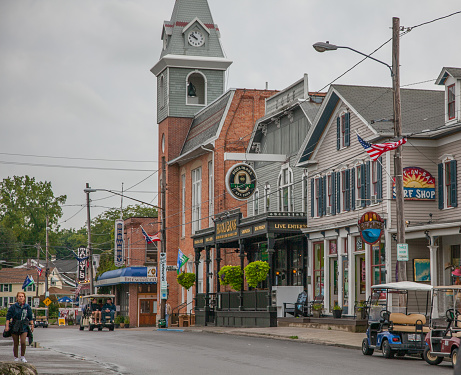 Tourists walk around the main commercial hub of Put-In-Bay, Ohio on a cloudy summer day.