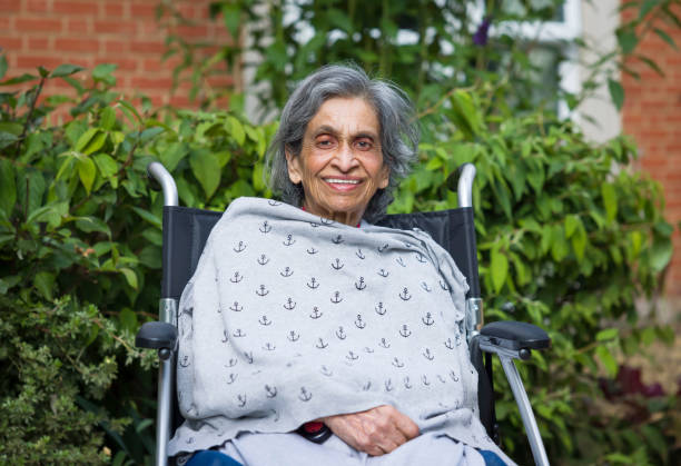 elderly asian indian woman in nursing home, care home or garden - fragility imagens e fotografias de stock