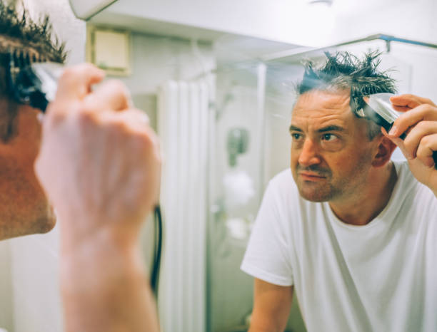 istock Man Cutting Hair at Home 1338398660