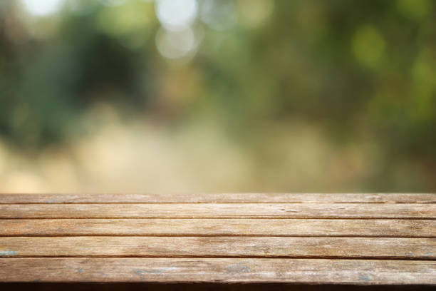 istock Empty rustic table in front of countryside background. product display and picnic concept 1338399300