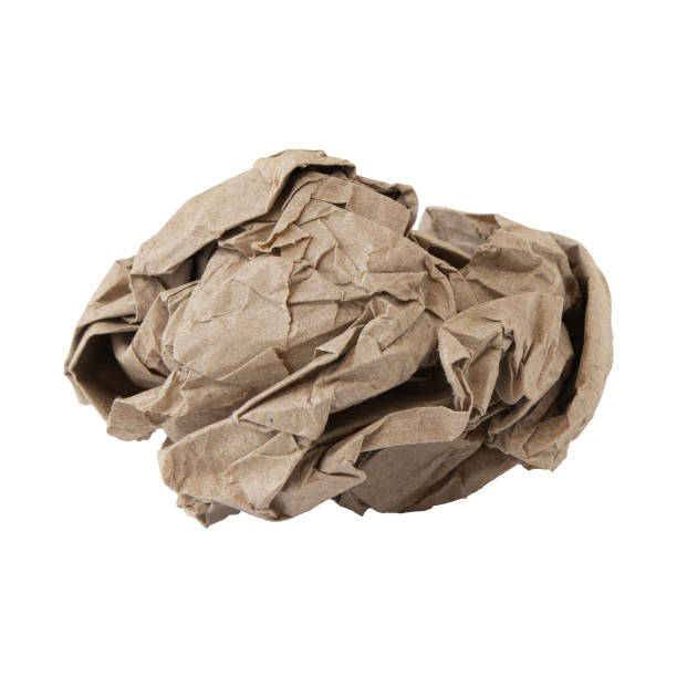istock crumpled brown paper ball on white background 1338400296