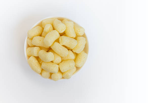 sweet corn sticks in bowl with ampty space for text isolated on white background, top view