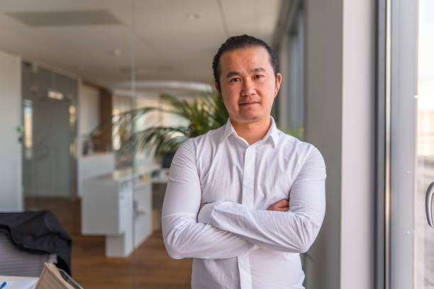istock Asian Businessman in 30's Standing With Hands Crossed 1338400805